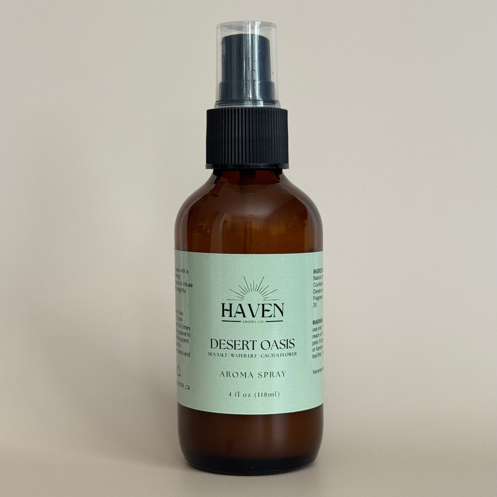 Amber spray bottle labeled 'Haven Desert Oasis' on a beige background