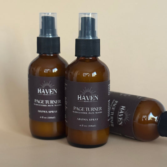 Two brown bottles of Haven Page Turner Aroma Spray on a beige background